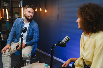 Podcasters recording a show in professional studio
