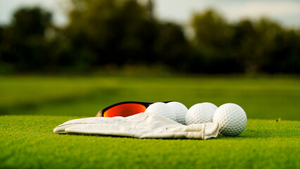 Golf Accessories on Green Grass with Balls and Gloves in Background