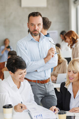 Fototapeta premium Business team engaging in discussion during a meeting in a modern office setting
