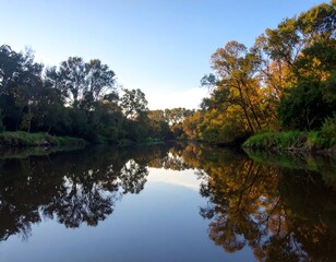 Fototapeta premium Calm river reflecting autumn trees