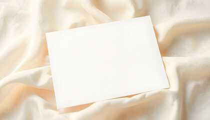 White invitation card mockup on a beige textile. 5x7 ratio, similar to A6, A5, dreamy atmosphere. White tone