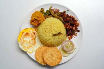 Yellow Rice and Curry with Omelet on White Ceramic Plate.