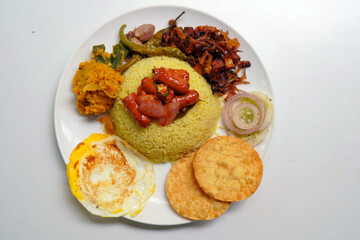 Traditional Sri Lankan Yellow Rice and Curry with Omelet Dish.