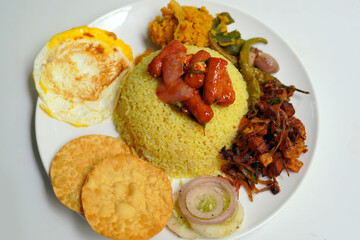 Yellow Traditional Rice and Curry Dish with Omelet on White Background.