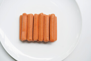 Fresh Sausages Resting on White Plate.