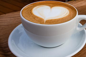 Heart Latte Art in White Coffee Cup on Wooden Table