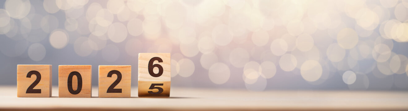 Flipping of 2025 to 2026 on wooden block cube for preparation new year change.New Year concept.
