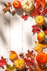 Autumn leaves, pumpkins and berries decorating a wooden table