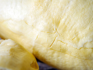 A yellow durian that has been peeled off to reveal the tasty yellow flesh of the durian. Close-up