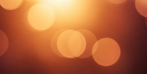 Abstract blurred lights orange and brown bokeh background, creating a warm natural tone that reflects autumn colors with soft glow, depth, and subtle ambience.