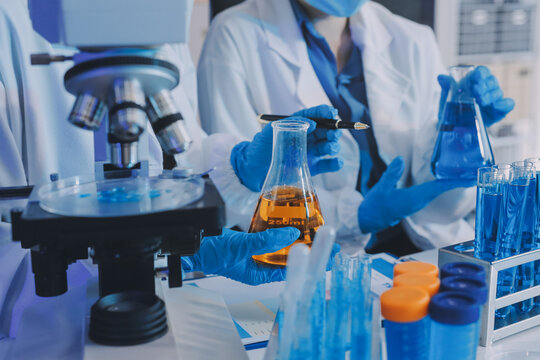 Collaboration, tablet or science with people in lab together for research or development. Innovation, tech and microscope with scientist team in clinical trial for planning or medical investigation