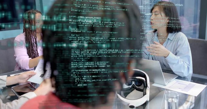 Korean woman handing prototype sheet to colleague and launching code overlay in VR project meeting