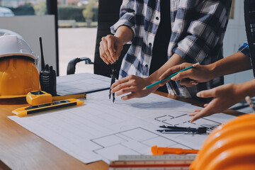 Construction and structure concept of engineer working drawing on blueprint meeting for project...