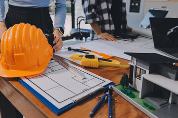 Construction and structure concept of engineer working drawing on blueprint meeting for project...