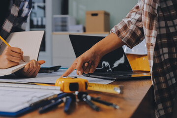 Construction and structure concept of engineer working drawing on blueprint meeting for project working with partner on model building and engineering tools in working site, construction concept.