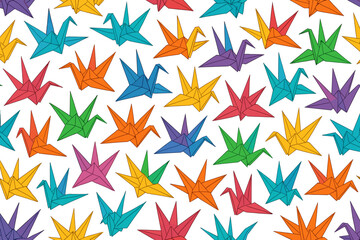 Obraz premium Colorful origami cranes and stars arranged in an artistic pattern on a white background