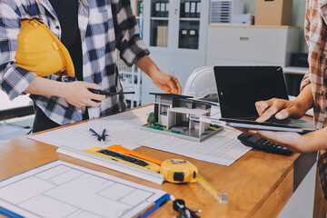 Construction and structure concept of engineer working drawing on blueprint meeting for project...