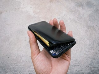 Damaged exploded powerbank smartphone charger due to battery swelling