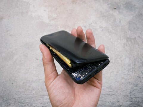 Damaged exploded powerbank smartphone charger due to battery swelling