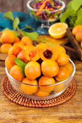 Fresh Organic Apricots in Glass Bowl on Rustic Wood Table with Healthy Summer Fruit Display