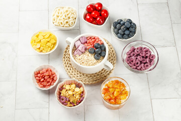Healthy Oatmeal Bowl with Fresh Fruit and Low Fat Cereal Treats for Weight Loss Diet on Light Background