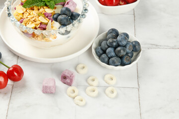 Healthy Breakfast Bowl with Yogurt Oats Blueberries and Fruit on White Background