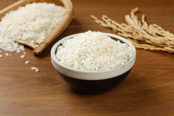 Fresh White Pearl Rice in Bowl with Wheat Stalks on Wooden Surface - Premium Grain Food Ingredient