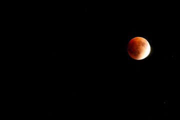 A beautiful rare blood moon on a dark night sky