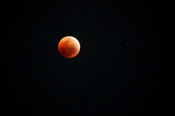 A beautiful rare blood moon on a dark night sky