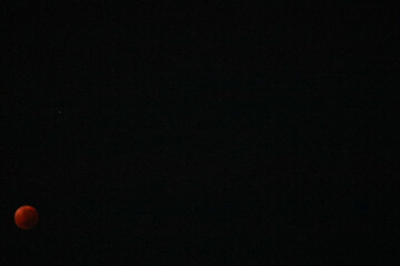 A beautiful rare blood moon on a dark night sky
