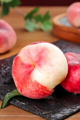 Fresh Red and White Peach Slices on Slate Board with Natural Lighting