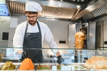 Chef preparing ingredients for shawarma or kebab in a fast food restaurant