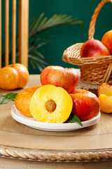 Fresh Golden Peaches from Shandong Province China with Cut Half Showing Yellow Flesh on Wooden Table