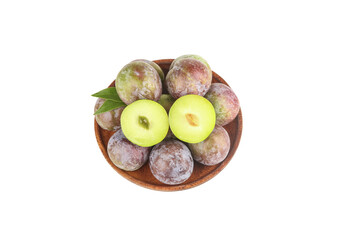 Fresh Green and Red Plums in Wooden Bowl Closeup with Cut Half Showing Yellow Flesh