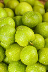 Fresh Green Plums with Water Droplets on Wooden Surface - Crisp Organic Stone Fruit