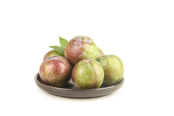 Fresh Red and Green Plums on Plate with Leaves Isolated on White Background