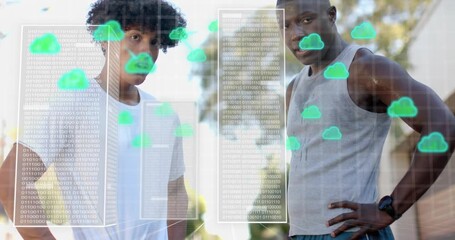 Two men leaning as binary code panel materializing and cloud icons forming technology cityscape - Powered by Adobe