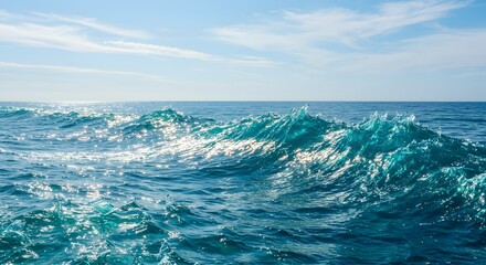 Fototapeta premium Captivating ocean waves under a bright blue sky. The waves are cresting and creating a mesmerizing sight