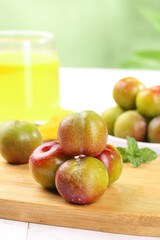 Fresh Red and Yellow Plums on Cutting Board Ready to Cut into Pieces