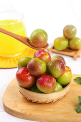 Fresh Ripe Plums in Bamboo Basket on Wooden Board - Healthy Organic Stone Fruit