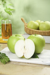 Fresh Green Apples with Juice Glass and Basket on Marble Board - Healthy Organic Fruit Display
