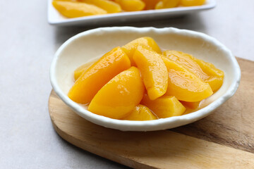 Sliced peaches in syrup served in a bowl