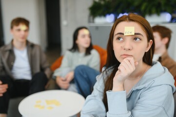 Woman thinking hard during guessing game with friends