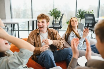 Friends playing guessing game with sticky notes on foreheads, laughing and having fun