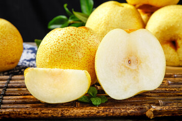 Fresh Dangshan Pears with White Flesh Slices on Bamboo Background - Healthy Organic Fruit Display