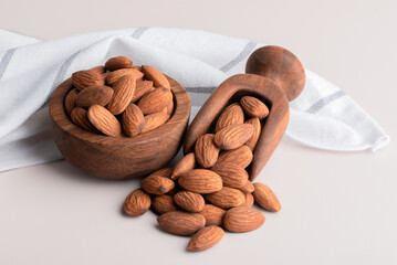 Whole almonds in a bowl on the table. Raw organic Almonds are high in protein.	
