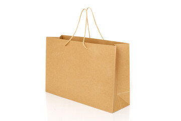 Side view of a brown paper shopping bag isolated on white background