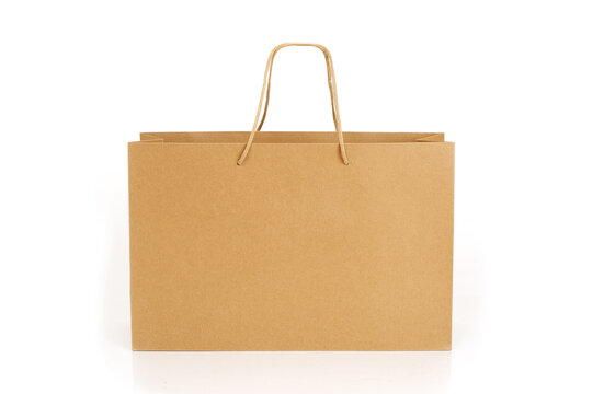 Brown paper shopping bag isolated on white background