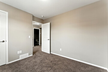 Bedroom with a white door and a white wall