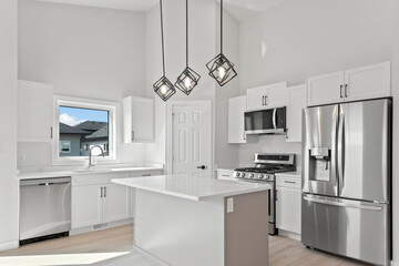Kitchen with a white island and stainless steel appliances